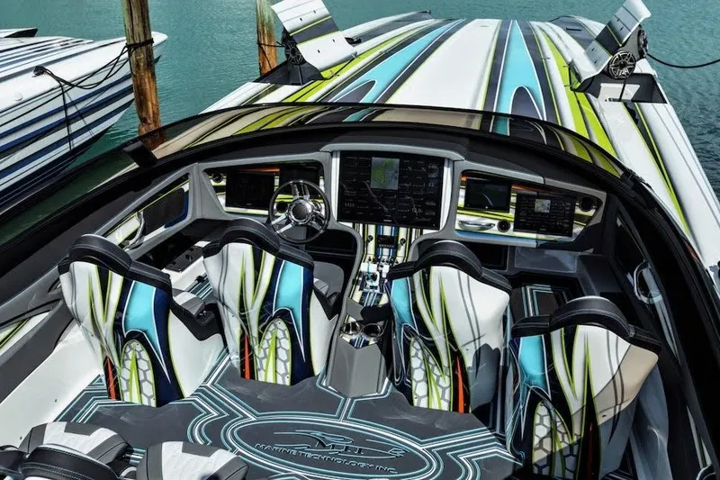 Slide: The Image of Luxury MTI 48 speedboat interior with vibrant design, advanced controls, and modern seating, 2022 model. - 5
