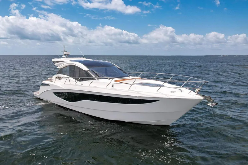 The Image of 2017 Galeon 445 HTS yacht cruising on open water under a clear blue sky. - 0