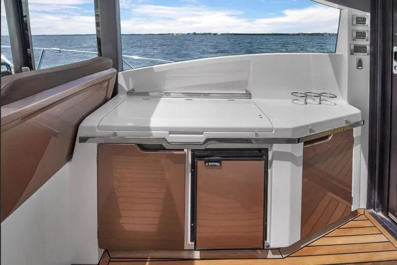 Slide: The Image of 2017 Galeon 445 HTS yacht interior with sleek kitchenette and ocean view. - 3