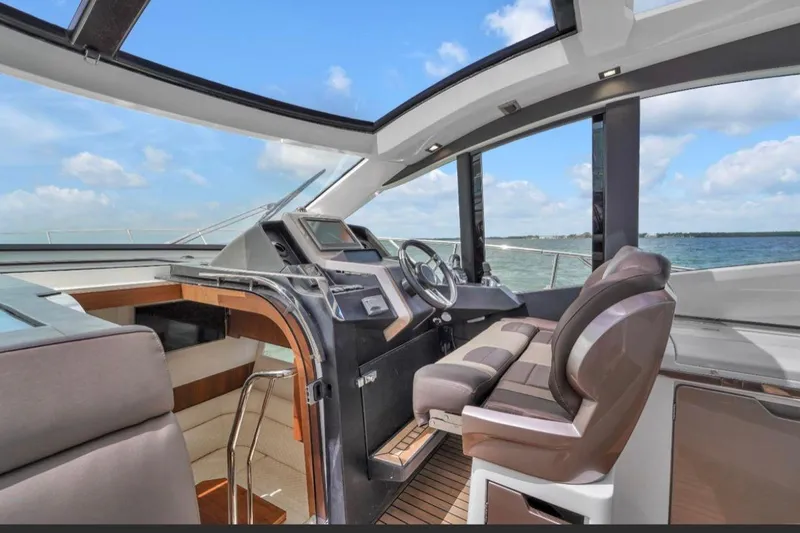 Slide: The Image of 2017 Galeon 445 HTS yacht interior with modern helm and panoramic sea view. - 6