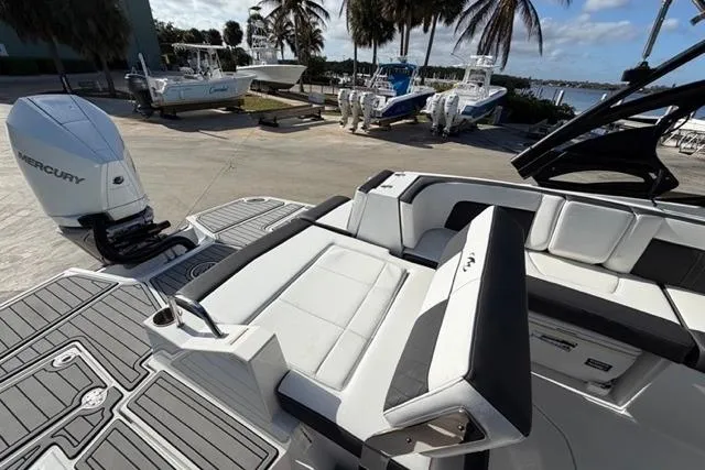 Slide: The Image of 2021 Monterey M-65 boat with Mercury engine, docked near palm trees and other boats. - 10