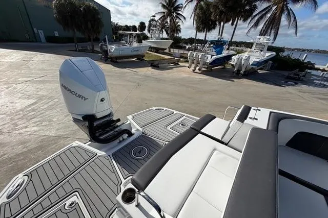 Slide: The Image of 2021 Monterey M-65 boat with Mercury engine, docked near palm trees and other boats. - 11