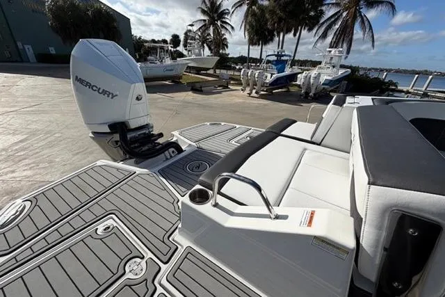 Slide: The Image of 2021 Monterey M-65 boat with Mercury engine, docked near palm trees and water. - 12