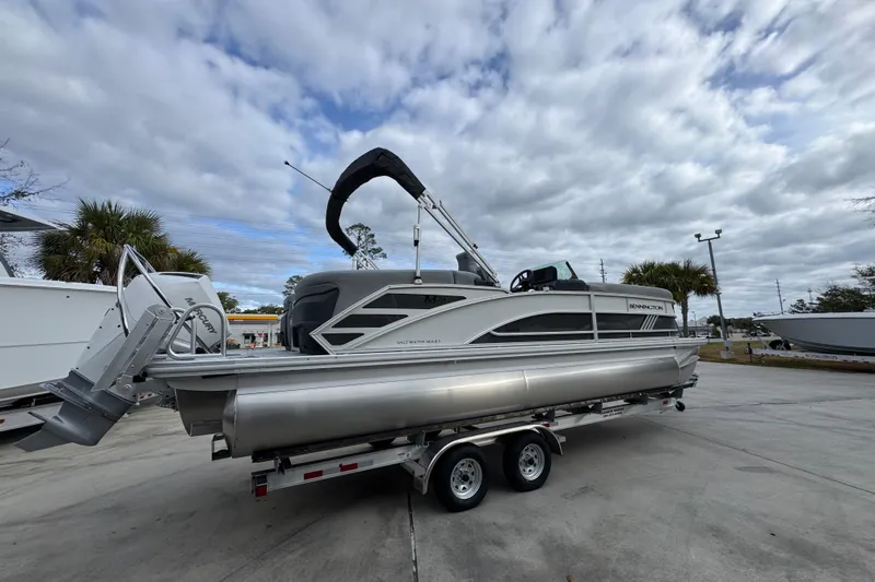 Slide: The Image of 2026 Bennington 24 MFB pontoon boat on trailer under cloudy sky. - 10