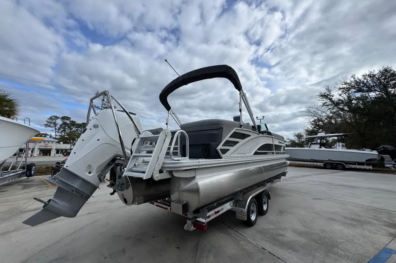 Slide: The Image of 2026 Bennington 24 MFB pontoon boat on trailer under cloudy sky. - 11
