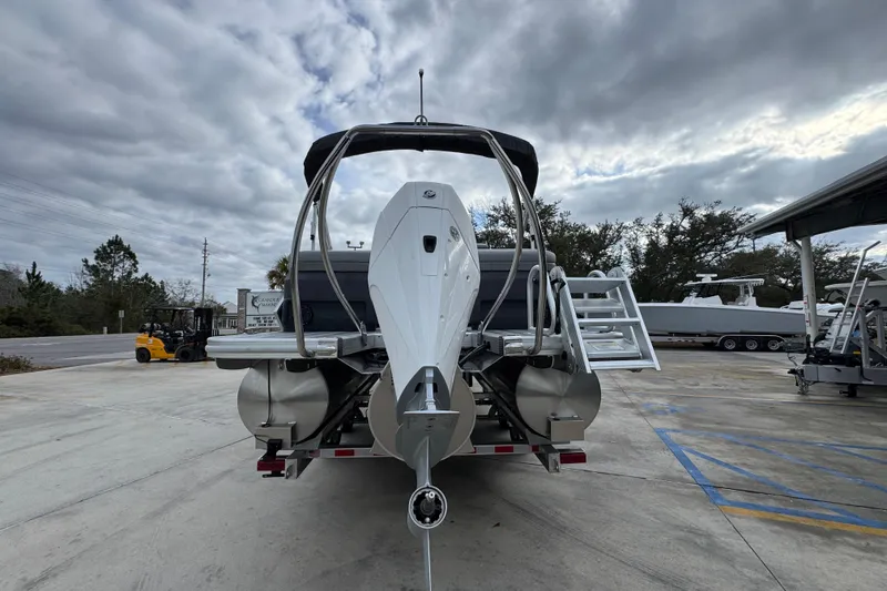 Slide: The Image of 2026 Bennington 24 MFB pontoon boat on trailer under cloudy sky. - 13