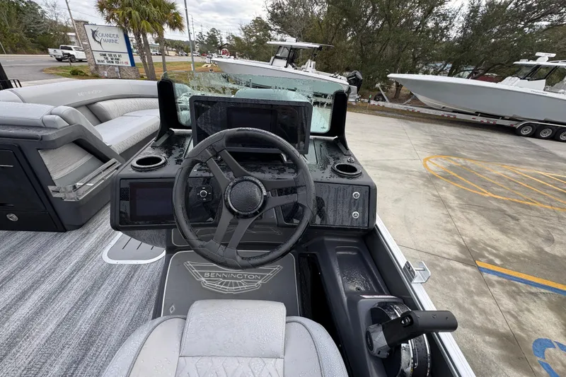 Slide: The Image of 2026 Bennington 24 MFB boat dashboard with steering wheel and controls. - 25