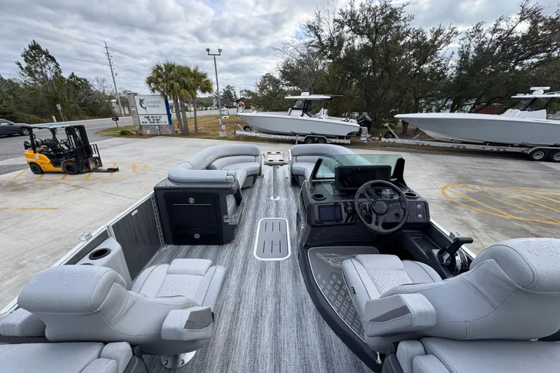 Slide: The Image of 2026 Bennington 24 MFB pontoon boat with luxurious seating and modern dashboard. - 26