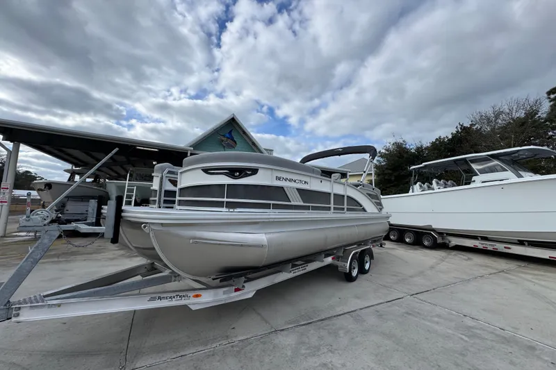 Slide: The Image of 2026 Bennington 24 MFB pontoon boat on trailer under cloudy sky. - 3