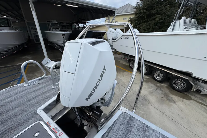 Slide: The Image of 2026 Bennington 24 MFB boat with Mercury outboard engine in a marina setting. - 31