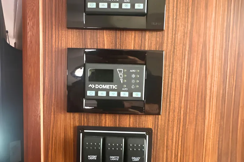 Slide: The Image of Control panel on 2017 Pursuit OS 355 Offshore boat with Dometic system. - 17