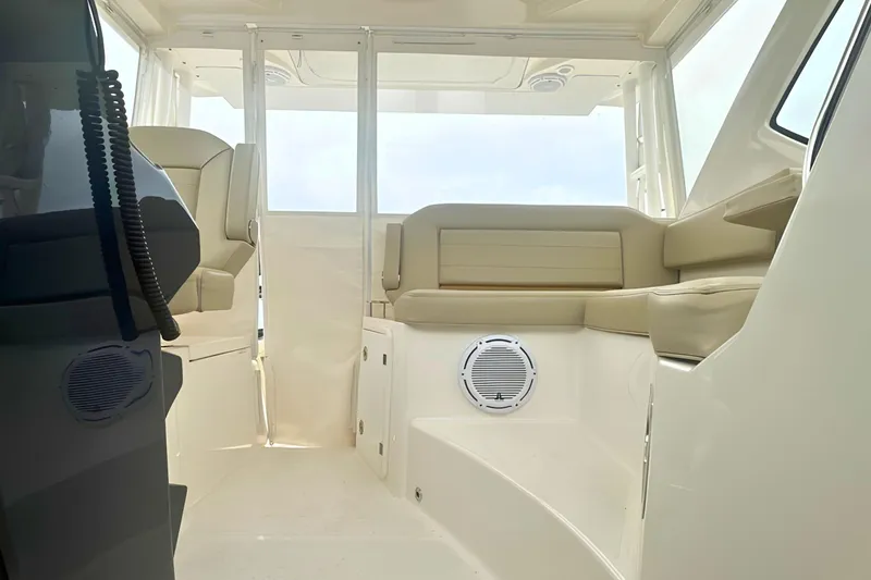 Slide: The Image of Interior of 2017 Pursuit OS 355 Offshore boat with beige seating and modern design. - 18