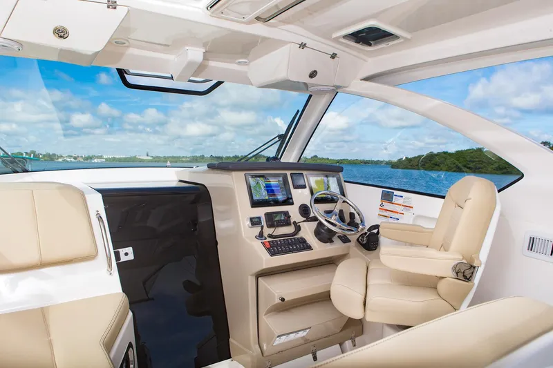Slide: The Image of Manufacturer Provided Image: 2017 Pursuit OS 355 Offshore boat interior with navigation system and leather seating. - 4