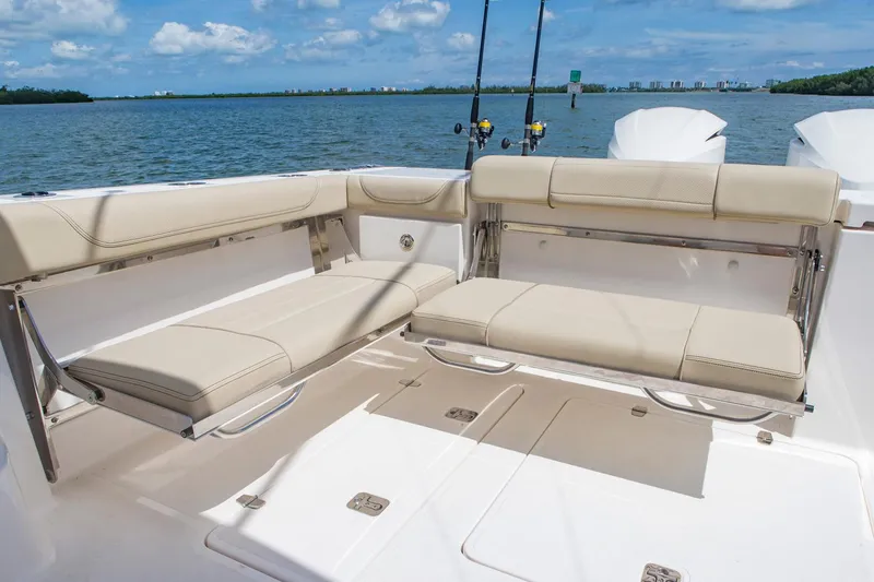 Slide: The Image of Manufacturer Provided Image: 2017 Pursuit OS 355 Offshore boat with beige seating and fishing rods. - 6