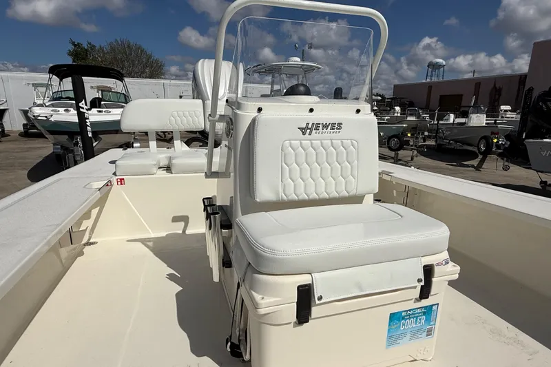 Slide: The Image of 2026 Hewes Redfisher 21 boat with white seating and Engel cooler on deck. - 10