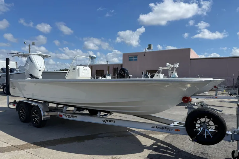 Slide: The Image of 2026 Hewes Redfisher 21 boat on trailer under blue sky. - 14