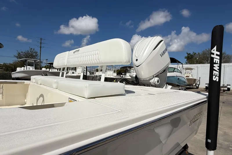Slide: The Image of 2026 Hewes Redfisher 21 boat with Yamaha engine, white seating, and clear blue sky. - 3