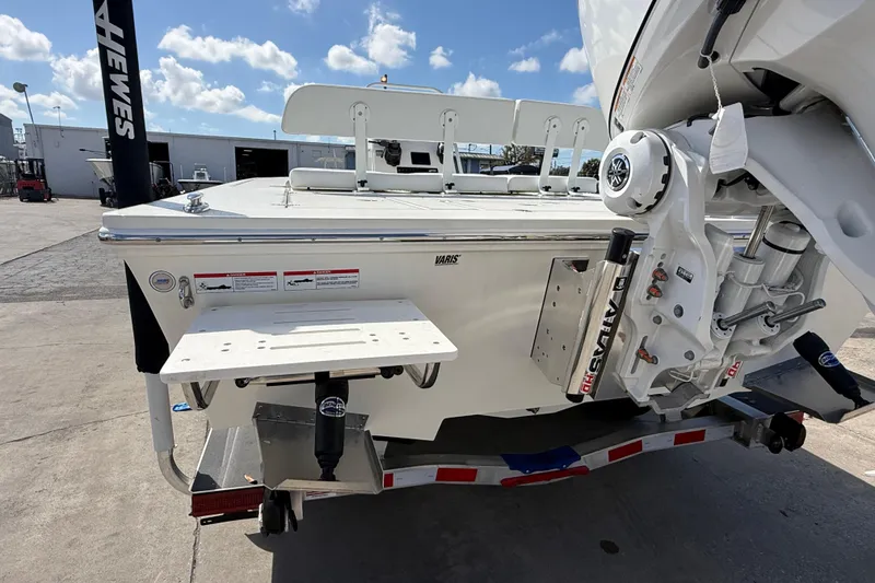 Slide: The Image of 2026 Hewes Redfisher 21 boat on trailer, rear view with motor and platform. - 5