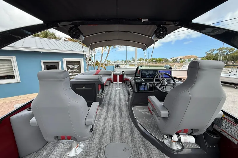 Slide: The Image of Interior of 2026 Bennington 26 M Center Swingback boat with modern seating and controls. - 12