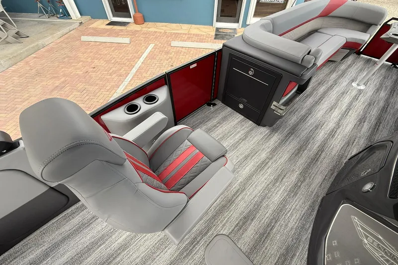Slide: The Image of 2026 Bennington 26 M Center Swingback boat interior with gray and red seating, modern design. - 14