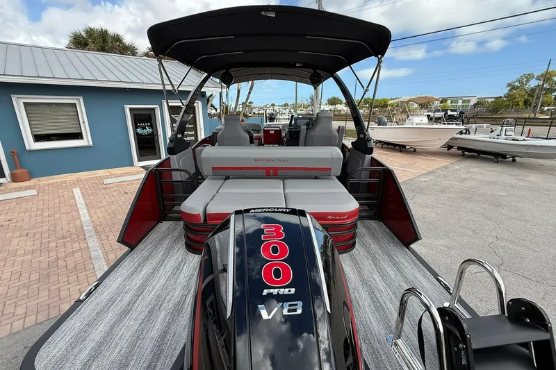 Slide: The Image of 2026 Bennington 26 M Center Swingback boat with Mercury 300 Pro V8 engine, docked outdoors. - 4