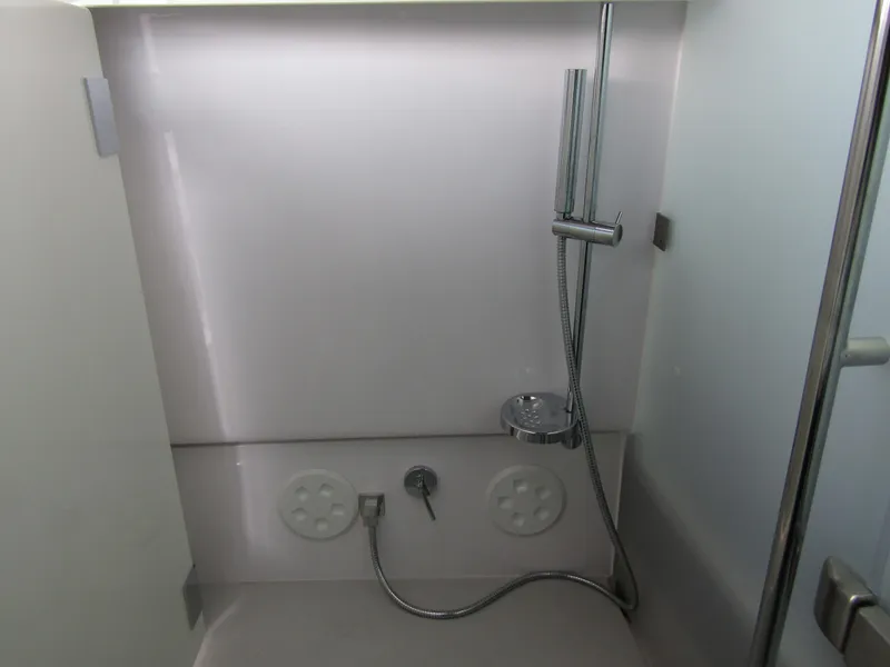 Slide: The Image of 2024 Axopar 37 Sun Top shower area with modern fixtures and sleek design. - 34