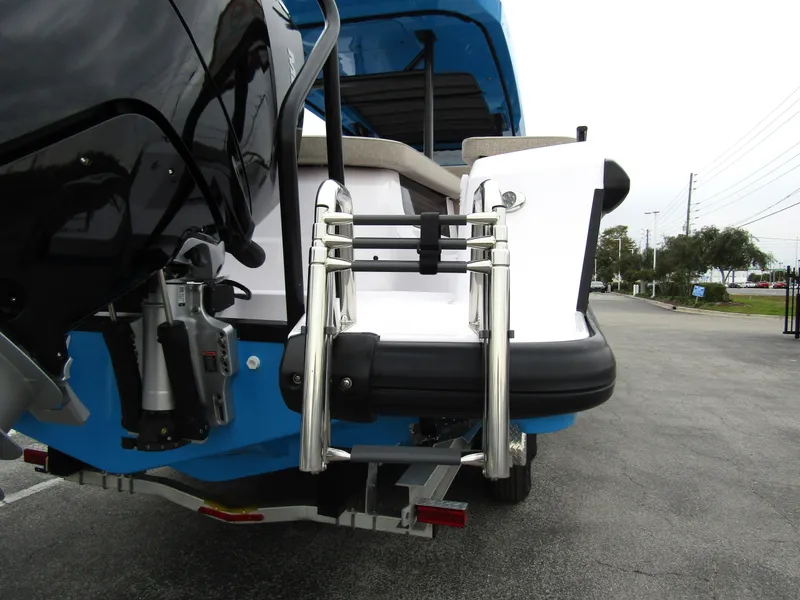 Slide: The Image of 2024 Axopar 37 Sun Top boat with rear ladder and seating area. - 6