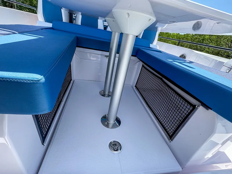 Slide: The Image of 2025 Axopar 37 Sun Top BRABUS Trim interior with blue seating and storage nets. - 10