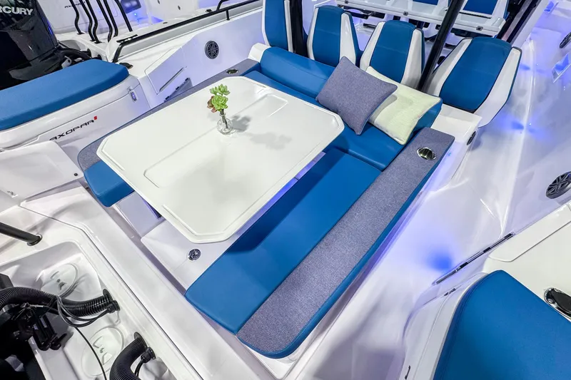 Slide: The Image of 2025 Axopar 37 Sun Top BRABUS Trim boat interior with blue seating and table. - 11