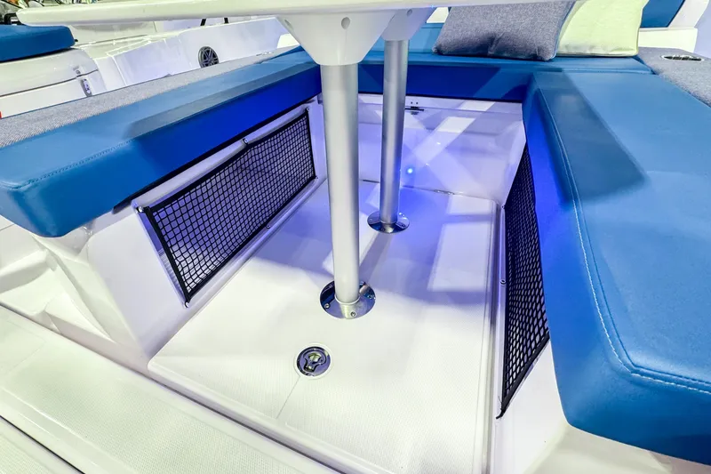 Slide: The Image of 2025 Axopar 37 Sun Top BRABUS Trim interior with blue seating and storage nets. - 12