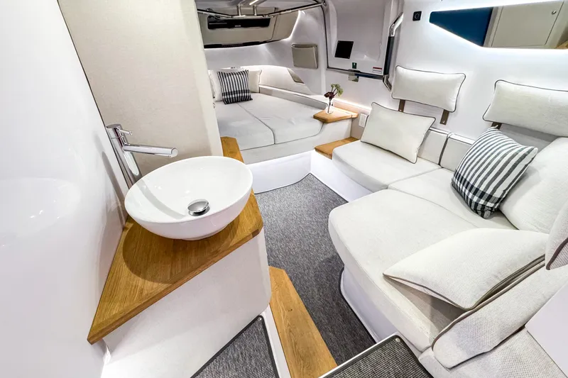 Slide: The Image of Luxurious interior of 2025 Axopar 37 Sun Top BRABUS Trim with modern seating and sink. - 30