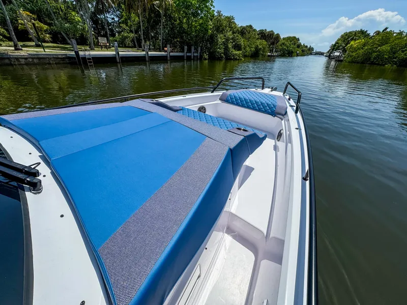 Slide: The Image of 2025 Axopar 37 Sun Top BRABUS Trim boat on a serene waterway. - 35