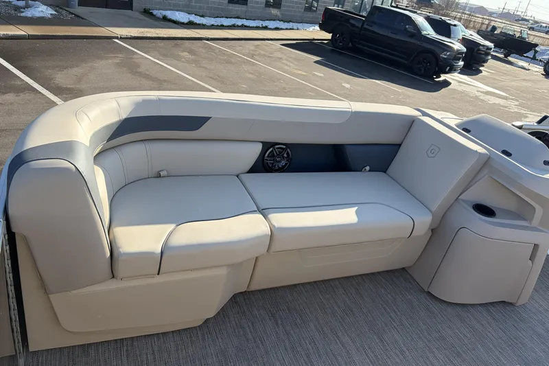 Slide: The Image of 2026 Godfrey Sweetwater 2086 C boat interior with beige seating in a parking lot. - 10