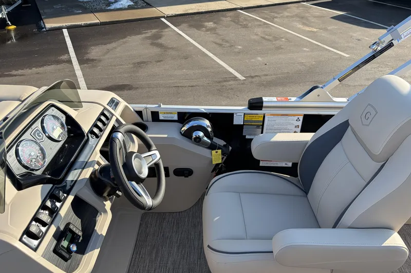 Slide: The Image of 2026 Godfrey Sweetwater 2086 C boat interior with steering wheel and captain's chair. - 13