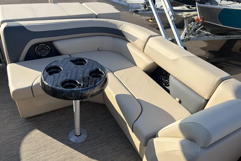 Slide: The Image of Luxurious seating area on 2026 Godfrey Sweetwater 2086 C pontoon boat with cupholder table. - 17