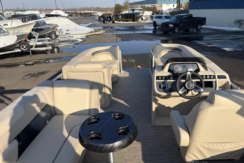 Slide: The Image of 2026 Godfrey Sweetwater 2086 C pontoon boat interior with beige seating and modern dashboard. - 18