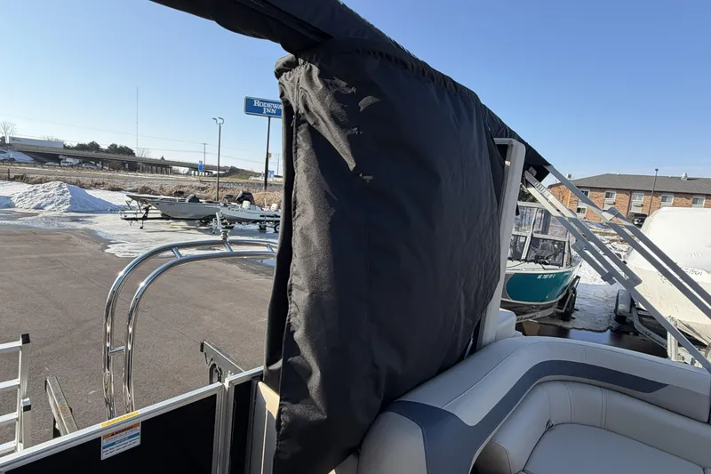 Slide: The Image of 2026 Godfrey Sweetwater 2086 C pontoon boat with covered seating, parked in snowy lot. - 19