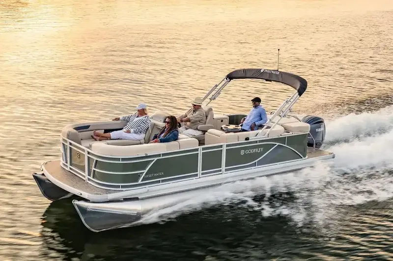 Slide: The Image of Manufacturer Provided Image: 2026 Godfrey Sweetwater Cruise pontoon boat on water with passengers enjoying a ride. - 26