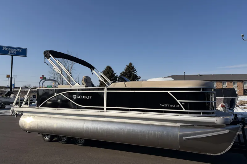 Slide: The Image of 2026 Godfrey Sweetwater 2086 C pontoon boat parked near Rodeway Inn. - 3