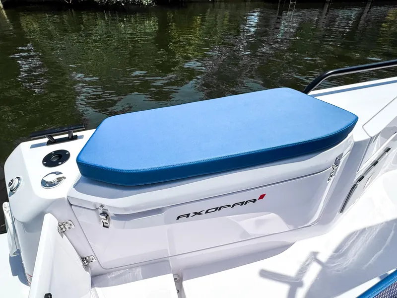 Slide: The Image of 2025 Axopar 37 Sun Top BRABUS Trim boat with blue cushioned seating. - 11