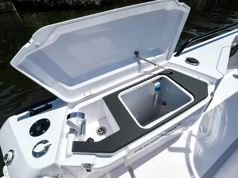 Slide: The Image of 2025 Axopar 37 Sun Top BRABUS Trim boat with open storage compartment. - 13