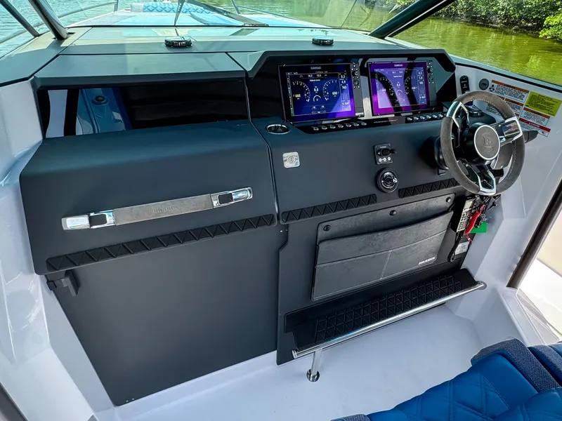 Slide: The Image of 2025 Axopar 37 Sun Top BRABUS Trim dashboard with advanced controls and steering wheel. - 19