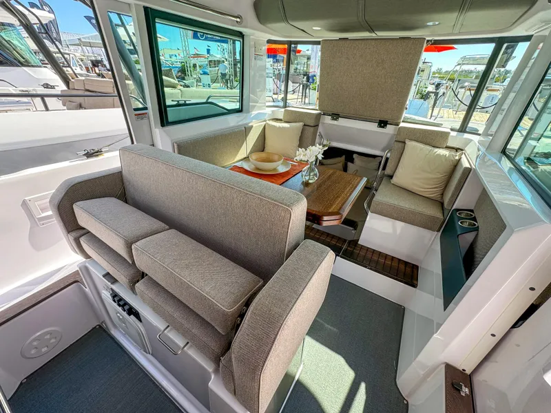 Slide: The Image of 2024 Axopar 37XC CROSS CABIN interior with modern seating and table setup. - 9