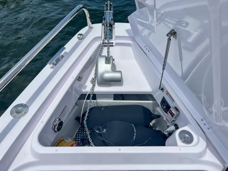 Slide: The Image of Anchor compartment of 2024 Axopar 37XC CROSS CABIN boat, featuring chain and winch. - 20