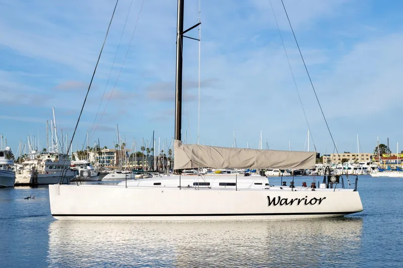 The Image of 2008 J Boats J/122 sailboat "Warrior" docked in a marina under a clear blue sky. - 0