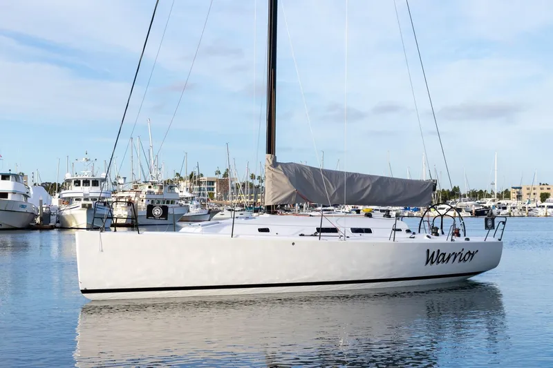 Slide: The Image of 2008 J Boats J/122 sailboat named "Warrior" docked in a marina. - 1