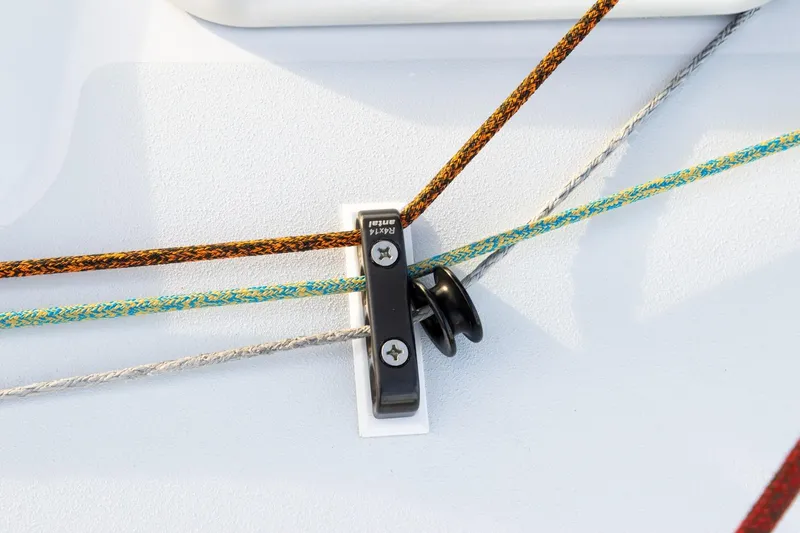 Slide: The Image of Close-up of J/122 sailboat rigging, featuring colorful ropes and a cleat, 2008 model. - 20