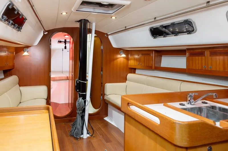 Slide: The Image of Interior of 2008 J Boats J/122 yacht, featuring wood finishes and navigation station. - 23