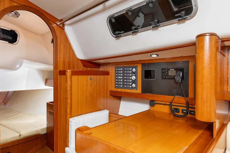 Slide: The Image of 2008 J Boats J/122 interior with navigation station and control panels. - 28