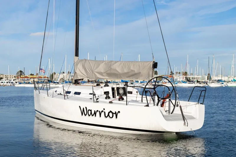 Slide: The Image of 2008 J Boats J/122 sailboat named "Warrior" docked in a marina. - 3